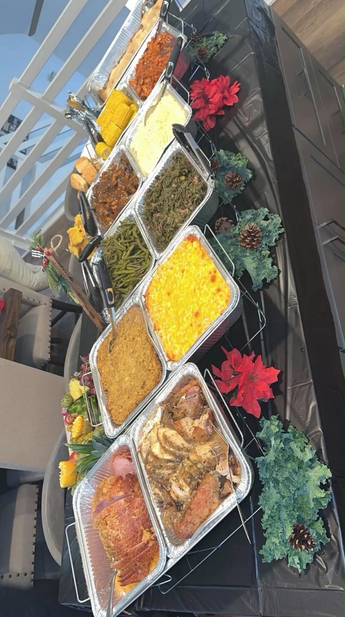Holiday buffet arranged with seasonal greenery